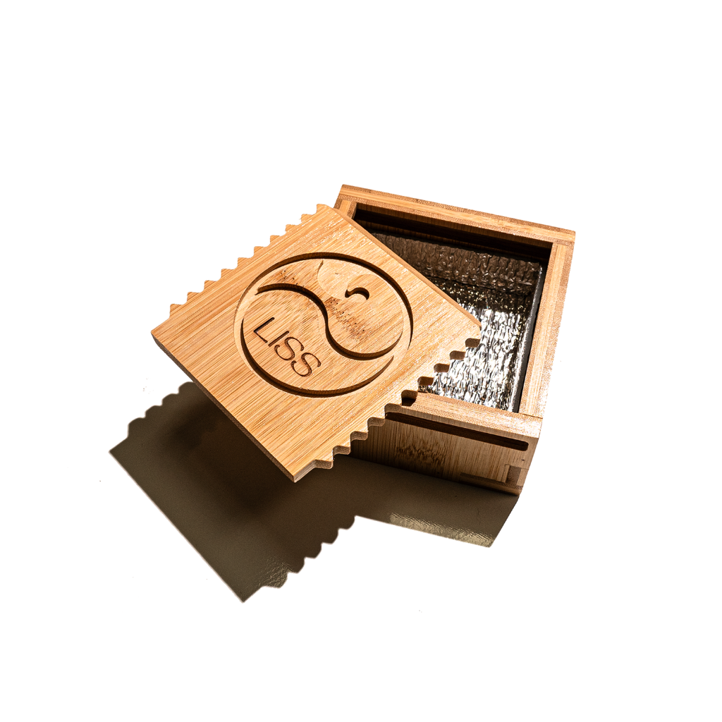 Open wooden surfboard wax box with engraved Liss logo and built-in grater