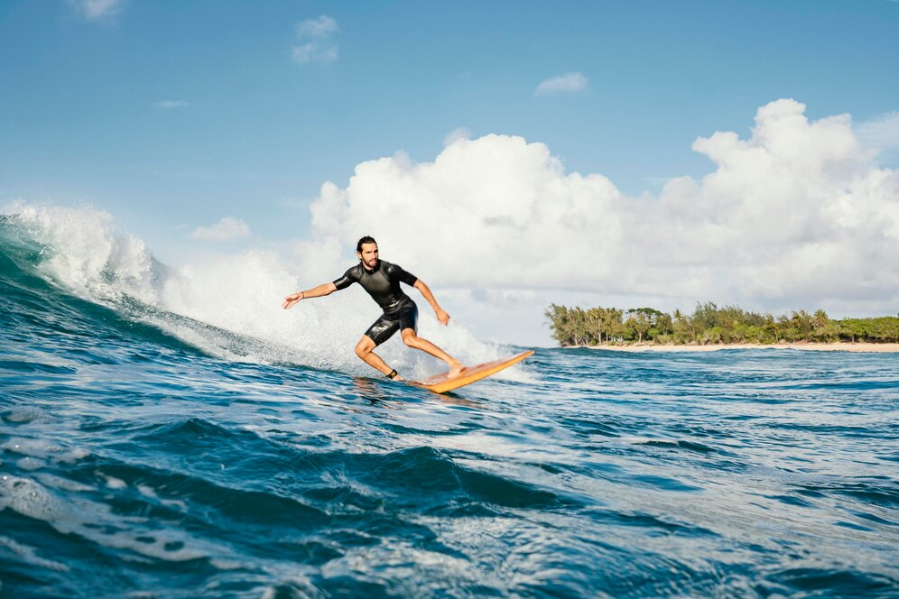 Man catching a large wave on his surfboard