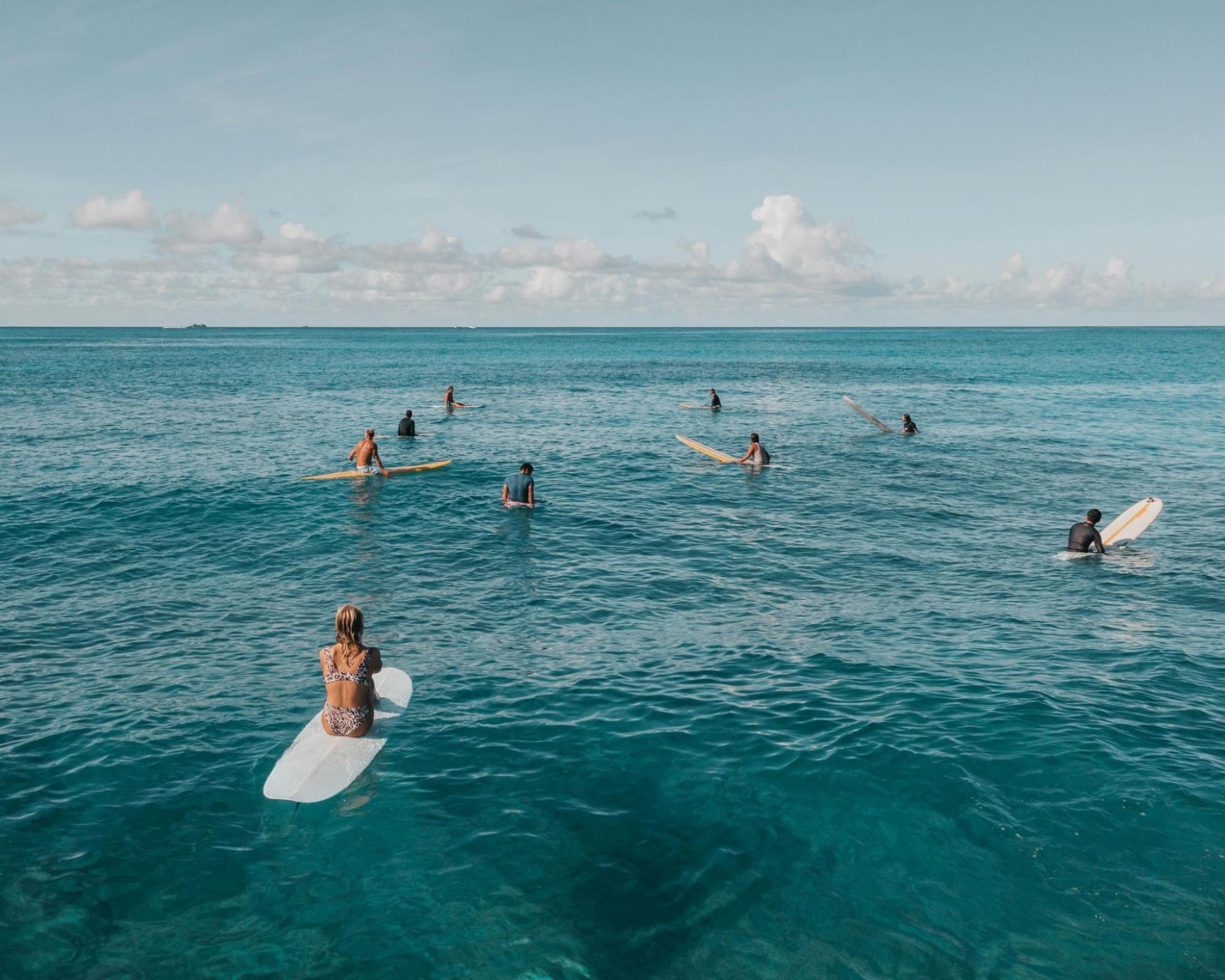 Surfers sitting on their surfboards in the water